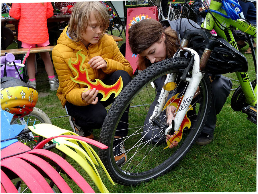 Reklame for arrangementet "Hjulestue". Billedet forestiller to unge mennesker der reparerer en cykel. 